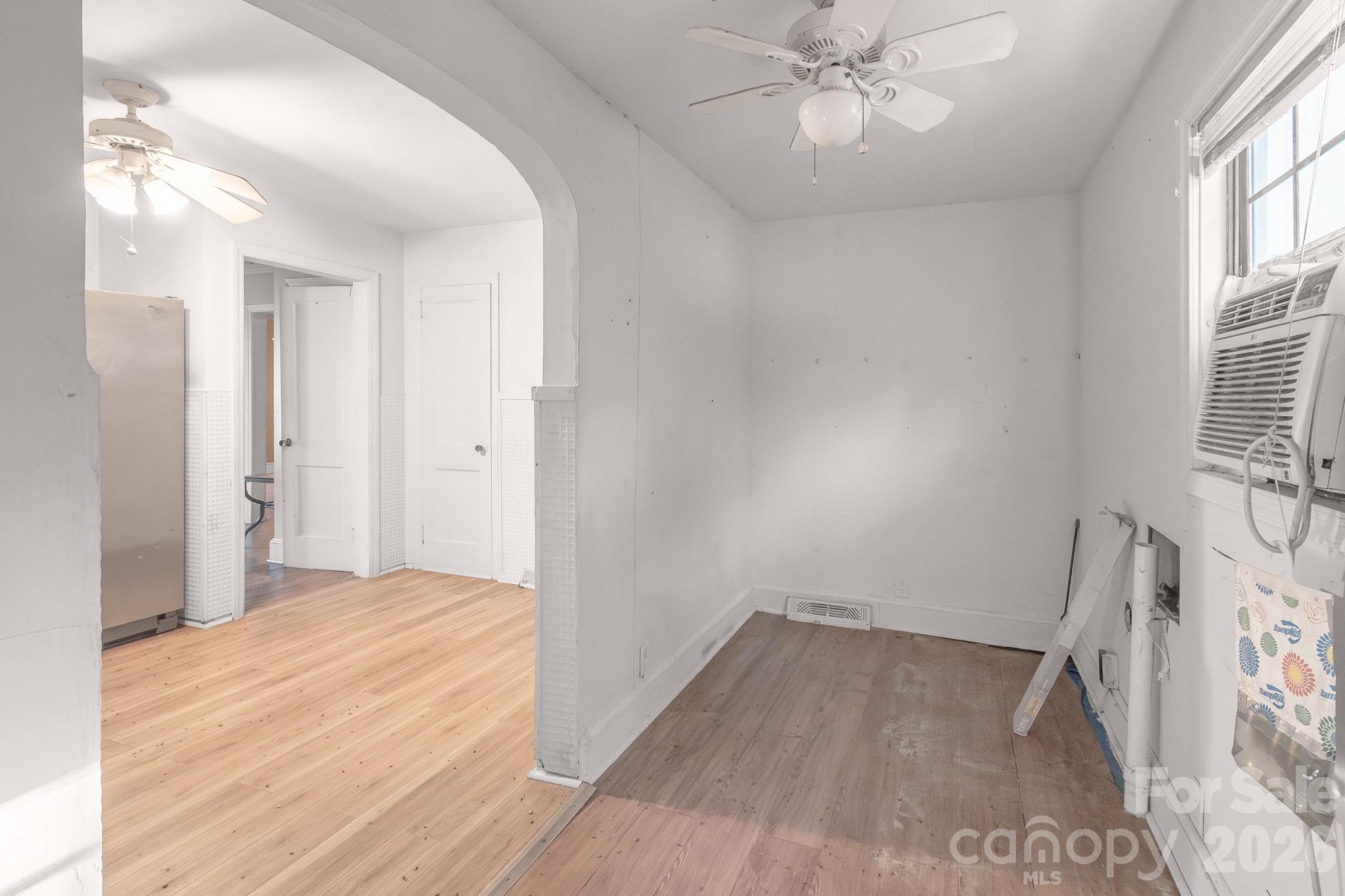4430 West Tyvola Road Charlotte, NC 28208 - Photo 17 of 33 a view of a livingroom with wooden floor and a ceiling fan