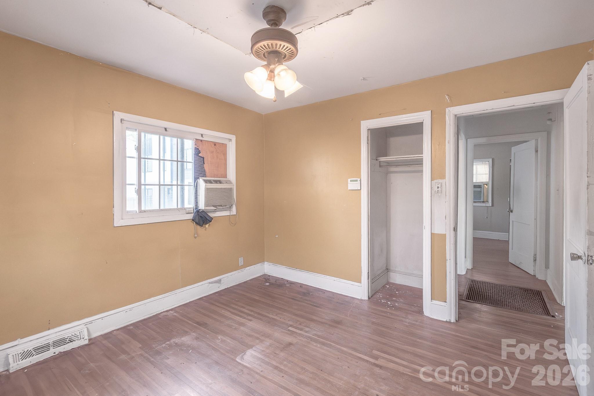 4430 West Tyvola Road Charlotte, NC 28208 - Photo 20 of 33 a view of an empty room with wooden floor and a window