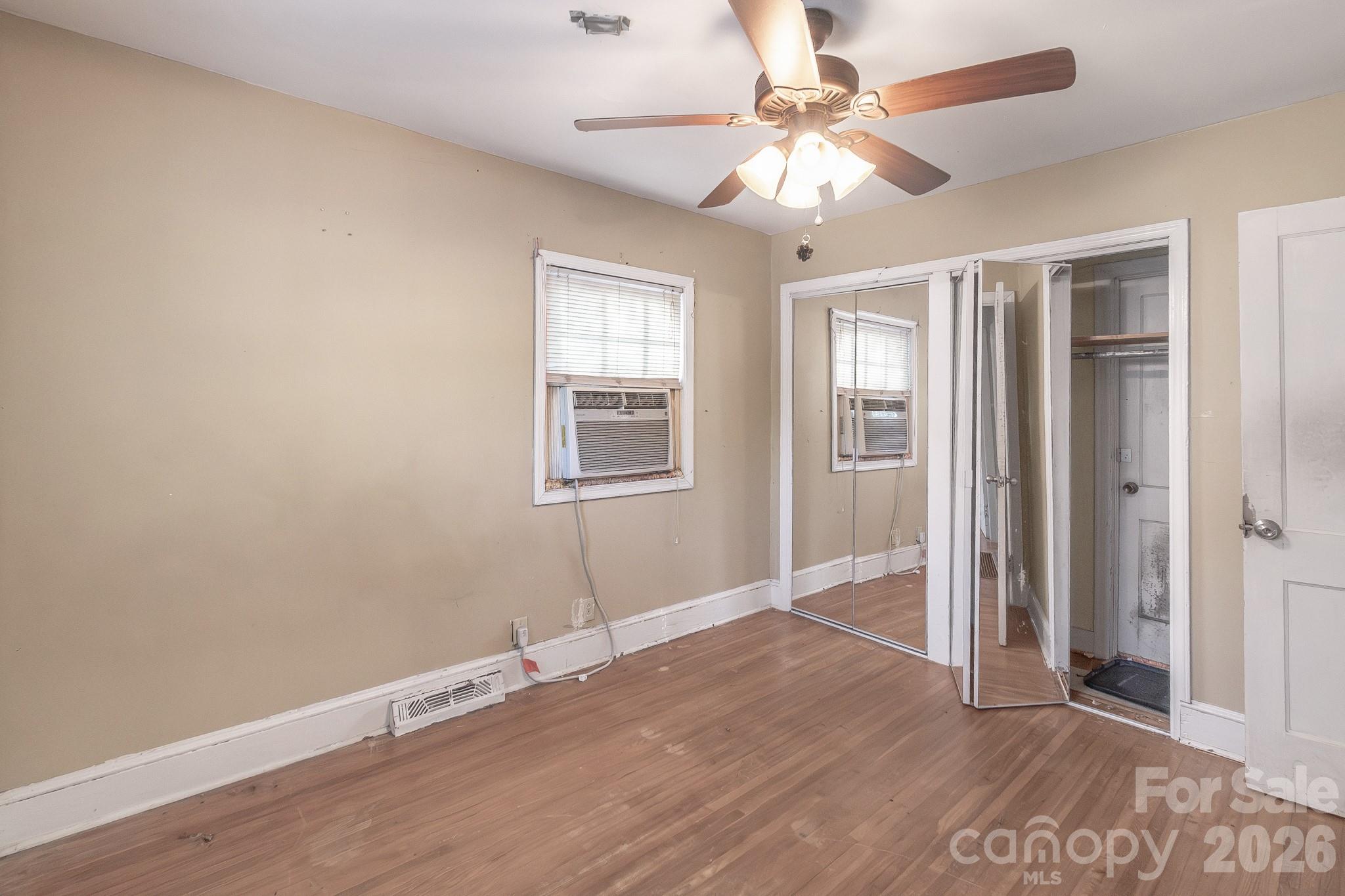 4430 West Tyvola Road Charlotte, NC 28208 - Photo 23 of 33 wooden floor in an empty room with a window