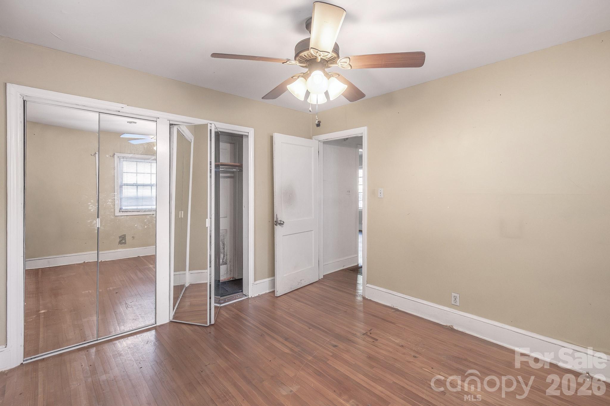 4430 West Tyvola Road Charlotte, NC 28208 - Photo 24 of 33 wooden floor in an empty room with a window