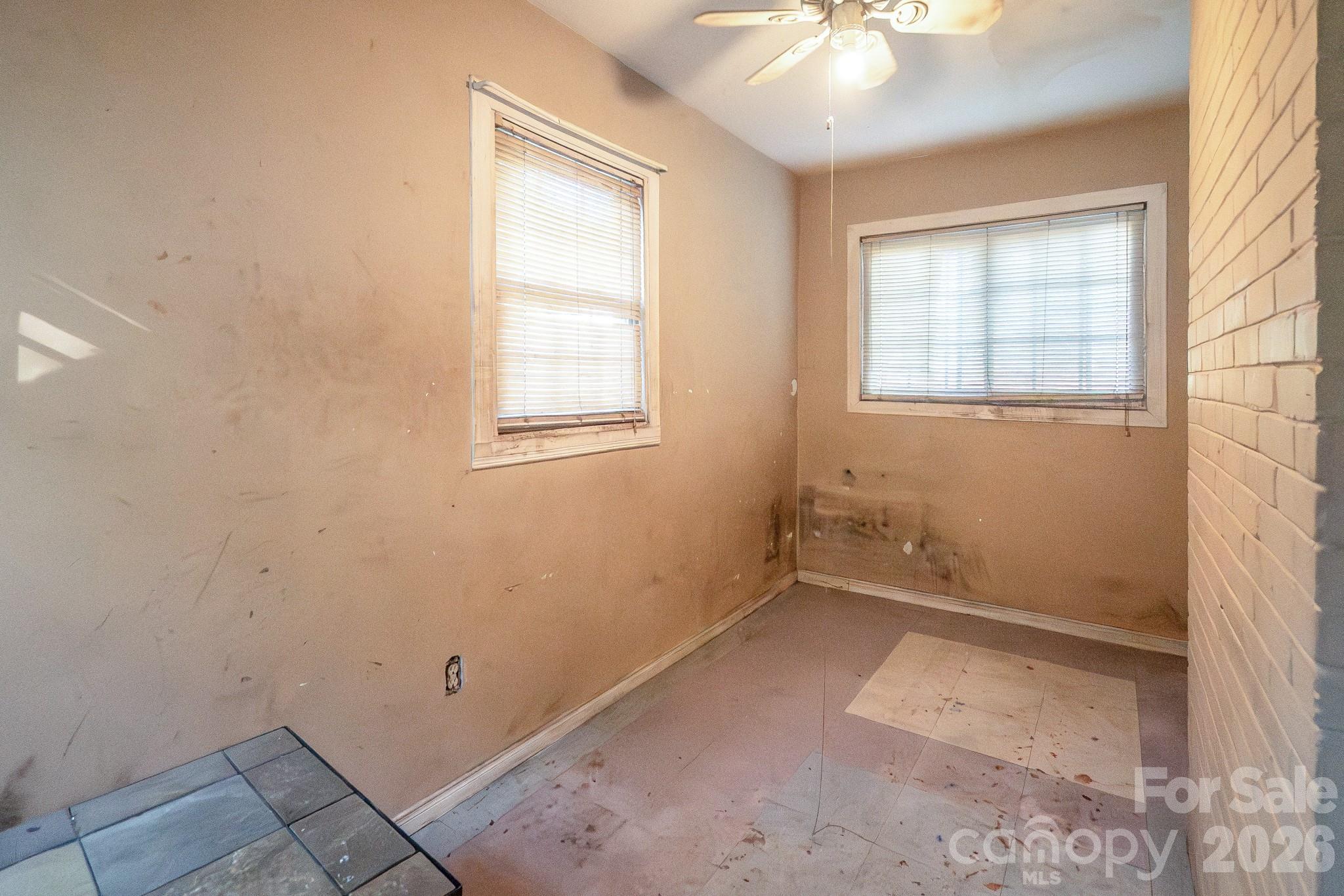 4430 West Tyvola Road Charlotte, NC 28208 - Photo 5 of 33 an empty room with windows and fan