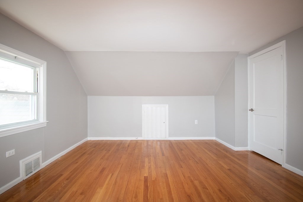 24 Lumae Street Springfield, MA 01119 - Photo 13 of 33 an empty room with wooden floor and windows
