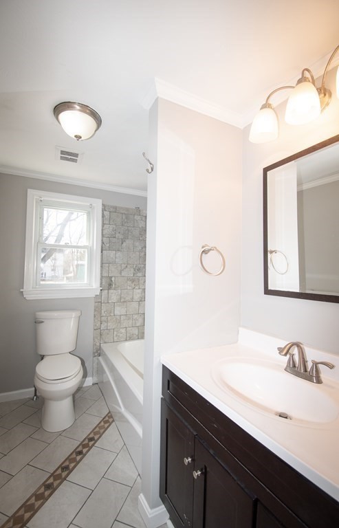 24 Lumae Street Springfield, MA 01119 - Photo 18 of 33 a bathroom with a sink a toilet and a mirror