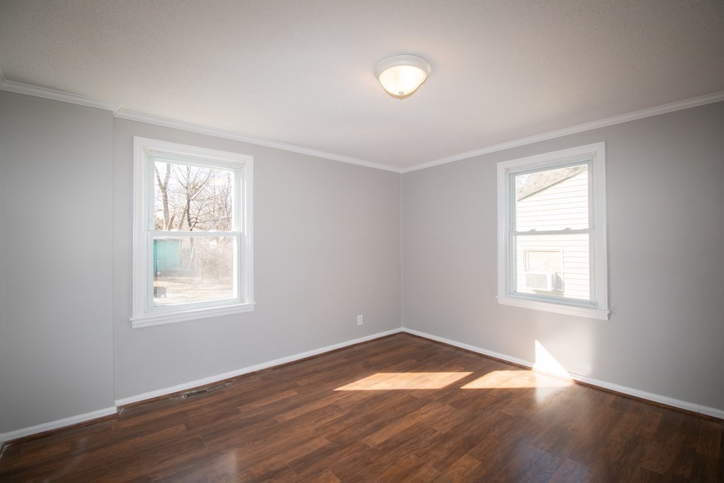 24 Lumae Street Springfield, MA 01119 - Photo 19 of 33 an empty room with wooden floor and windows
