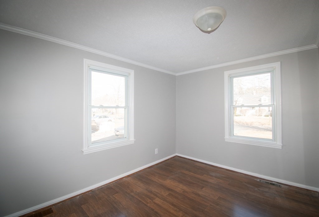24 Lumae Street Springfield, MA 01119 - Photo 21 of 33 an empty room with wooden floor and windows