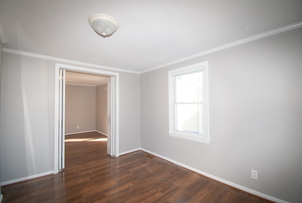 24 Lumae Street Springfield, MA 01119 - Photo 22 of 33 an empty room with wooden floor and windows