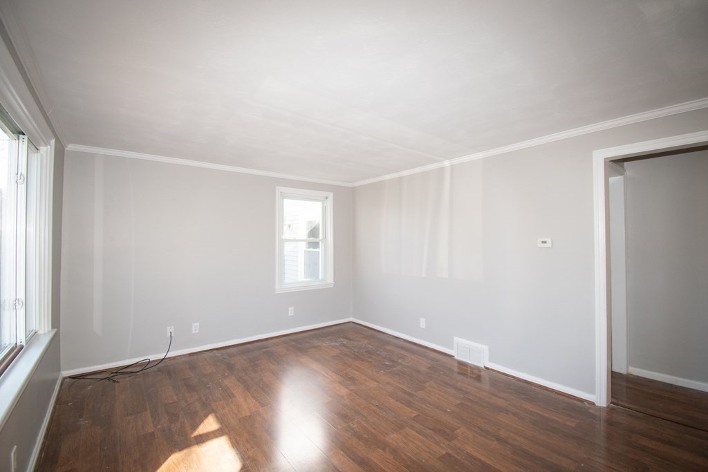 24 Lumae Street Springfield, MA 01119 - Photo 25 of 33 an empty room with wooden floor and windows