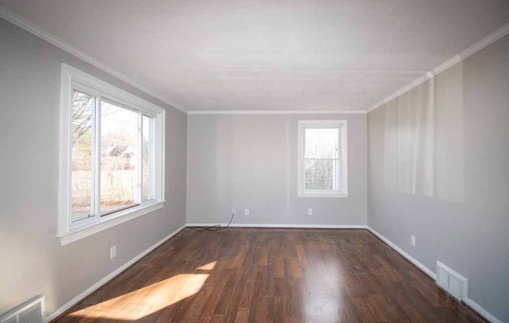 24 Lumae Street Springfield, MA 01119 - Photo 27 of 33 an empty room with wooden floor and windows