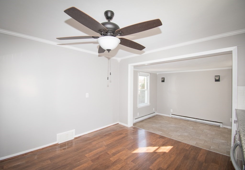 24 Lumae Street Springfield, MA 01119 - Photo 31 of 33 an empty room with wooden floor and a ceiling fan