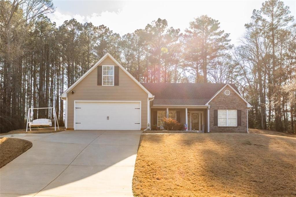 164 Laurel Lane Social Circle, GA 30025 - Photo 1 of 38 a front view of a house with a yard and garage