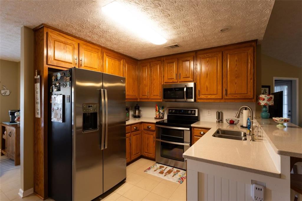 164 Laurel Lane Social Circle, GA 30025 - Photo 11 of 38 a kitchen with a refrigerator sink and microwave