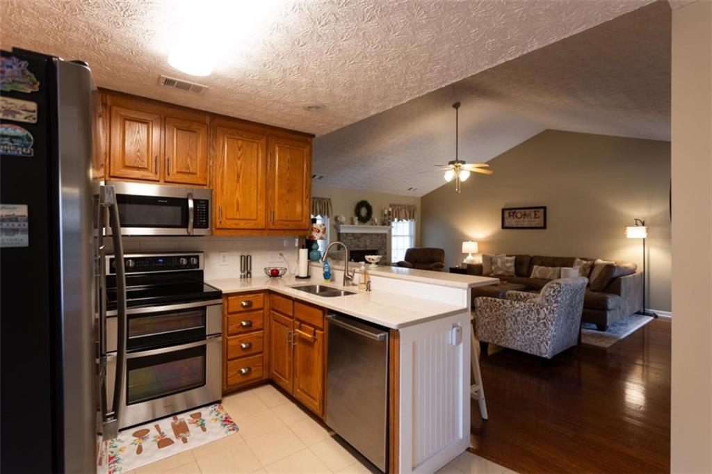 164 Laurel Lane Social Circle, GA 30025 - Photo 12 of 38 a kitchen with a sink stove and refrigerator