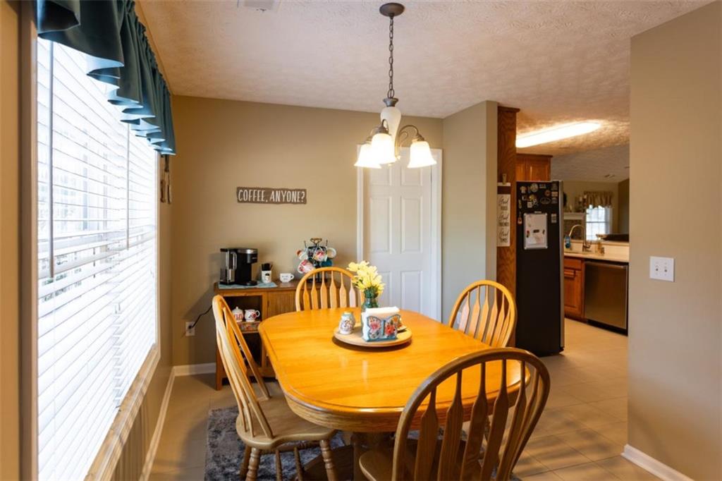 164 Laurel Lane Social Circle, GA 30025 - Photo 15 of 38 a view of a dining room with furniture and chandelier