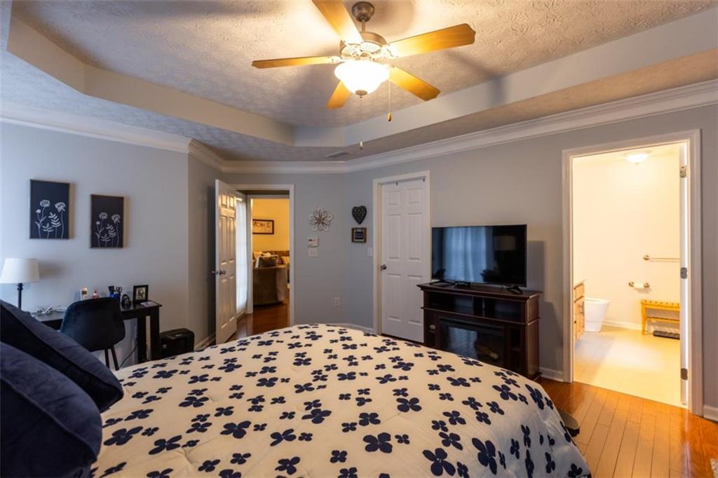 164 Laurel Lane Social Circle, GA 30025 - Photo 17 of 38 a bedroom with a bed and a flat tv screen on dresser