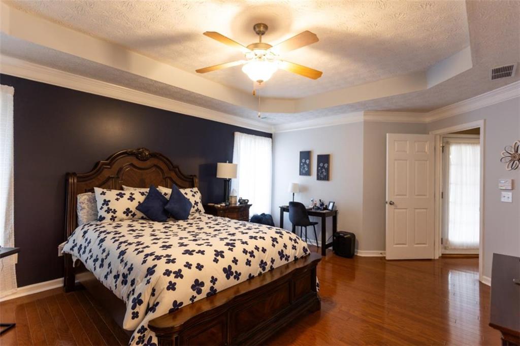 164 Laurel Lane Social Circle, GA 30025 - Photo 18 of 38 a bedroom with a bed and wooden floor