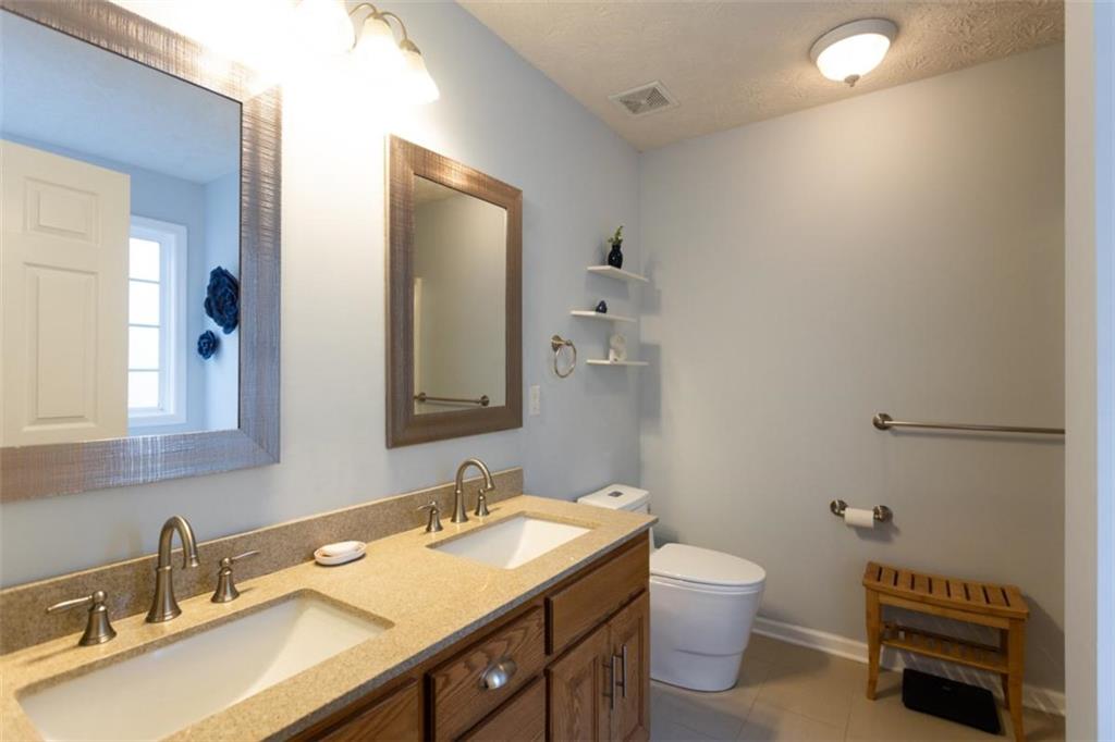 164 Laurel Lane Social Circle, GA 30025 - Photo 19 of 38 a bathroom with a sink a toilet and a mirror