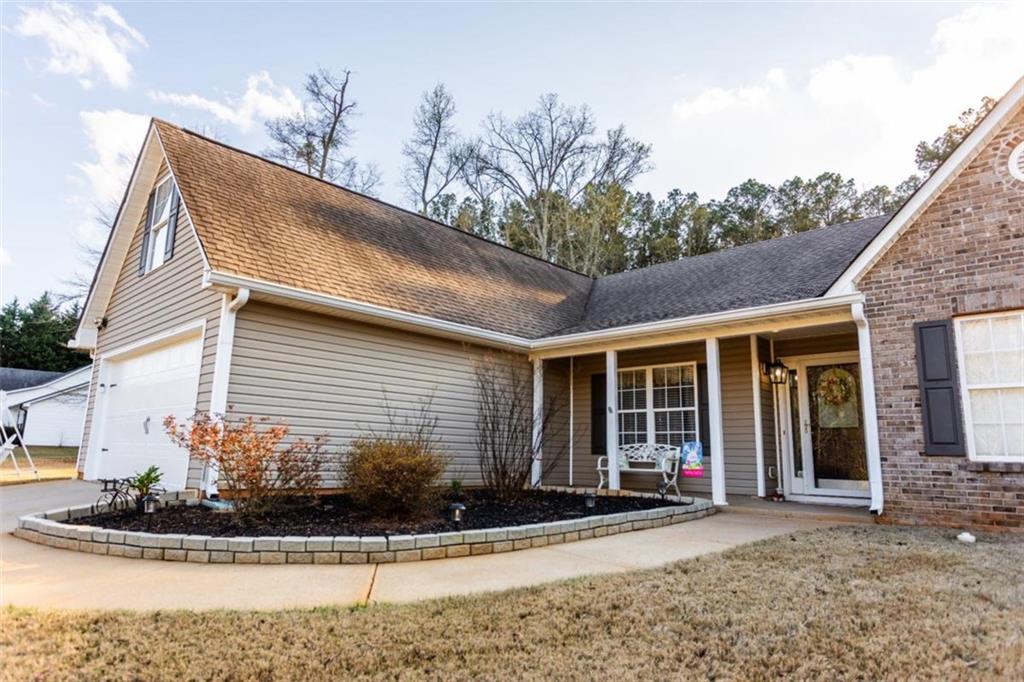 164 Laurel Lane Social Circle, GA 30025 - Photo 2 of 38 a front view of a house with porch and glass windows