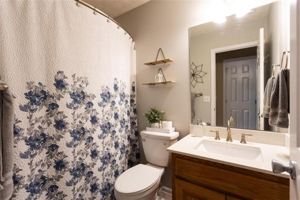 164 Laurel Lane Social Circle, GA 30025 - Photo 25 of 38 a bathroom with a sink a toilet and shower curtain