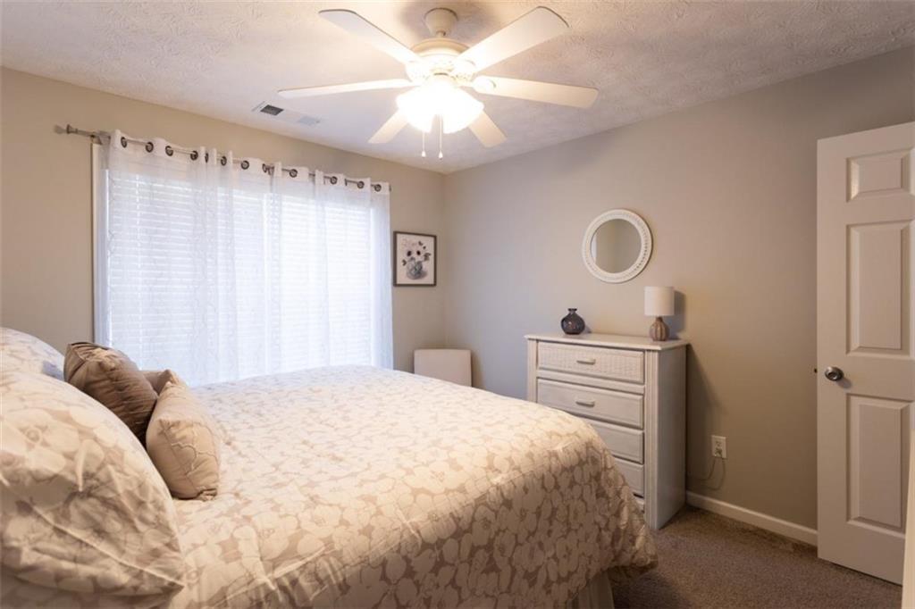 164 Laurel Lane Social Circle, GA 30025 - Photo 27 of 38 a bedroom with a bed and cabinets