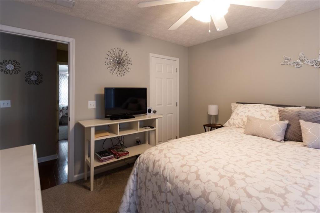 164 Laurel Lane Social Circle, GA 30025 - Photo 28 of 38 a bedroom with a bed and a flat screen tv
