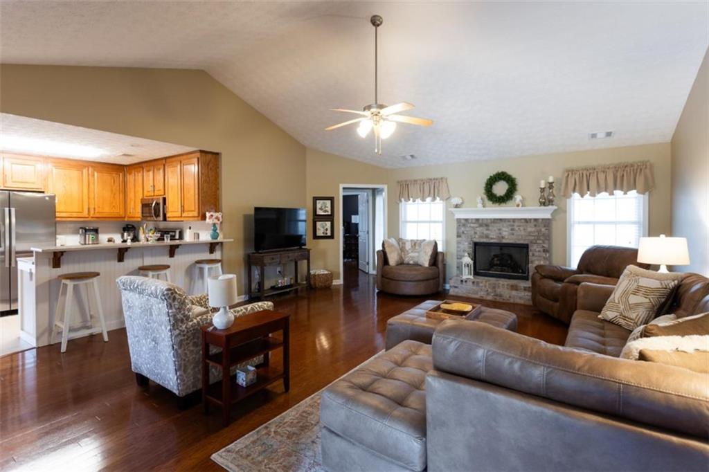 164 Laurel Lane Social Circle, GA 30025 - Photo 3 of 38 a living room with furniture a fireplace and a flat screen tv