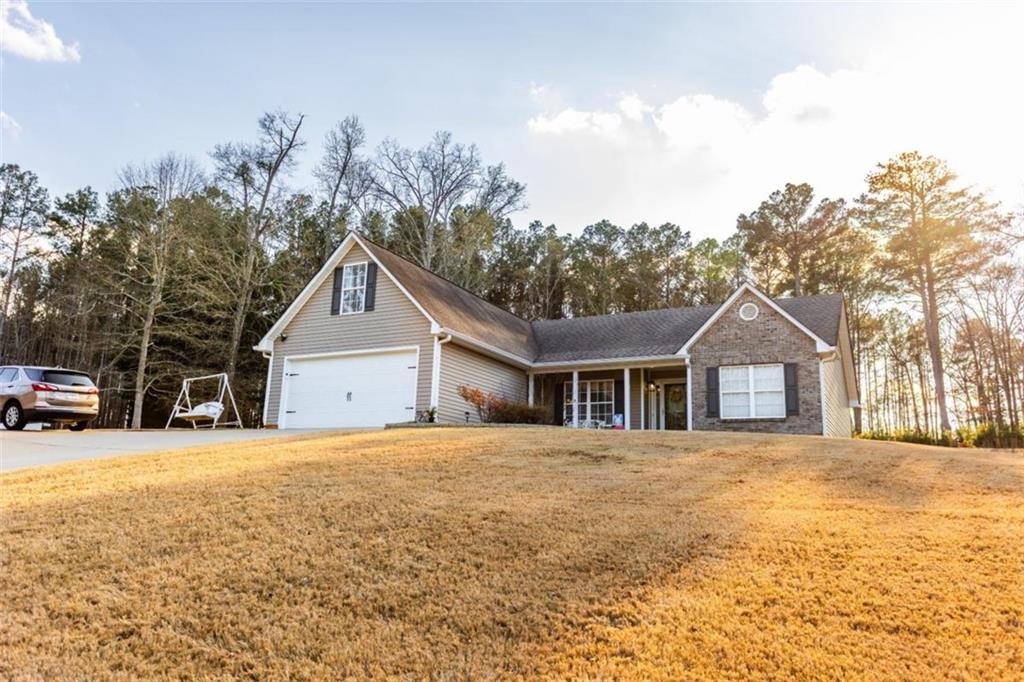 164 Laurel Lane Social Circle, GA 30025 - Photo 37 of 38 a front view of a house with a yard and trees