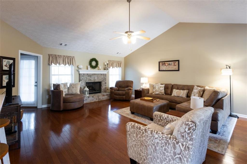 164 Laurel Lane Social Circle, GA 30025 - Photo 4 of 38 a living room with furniture a fireplace and a flat screen tv