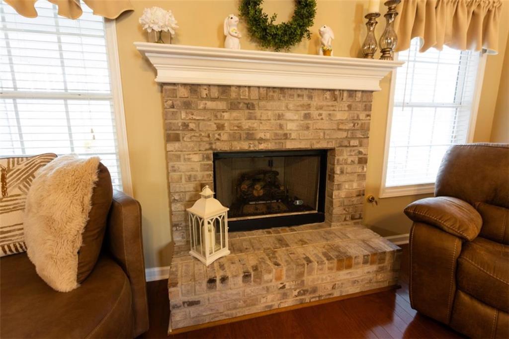 164 Laurel Lane Social Circle, GA 30025 - Photo 7 of 38 a living room with furniture rug and a fireplace