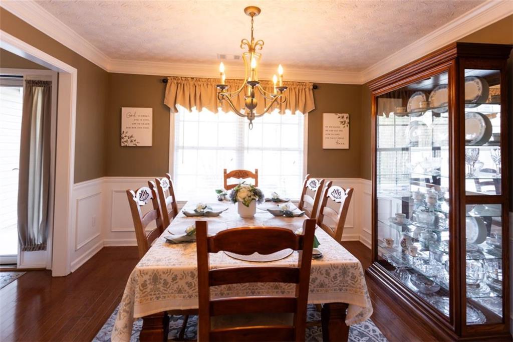 164 Laurel Lane Social Circle, GA 30025 - Photo 9 of 38 a dining room with furniture a chandelier and window