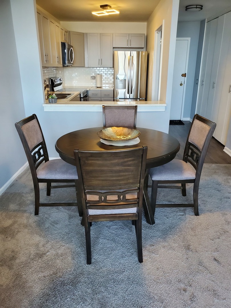 5415 North Sheridan Road, Unit 4809 Chicago, IL 60640 - Photo 7 of 12 a living room with a couch and a coffee table