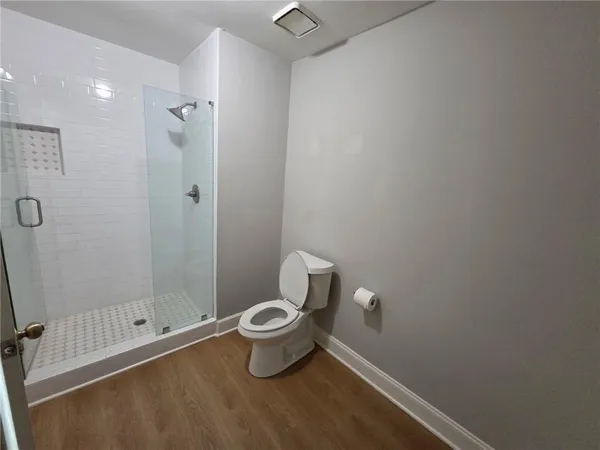 a bathroom with a toilet and a shower