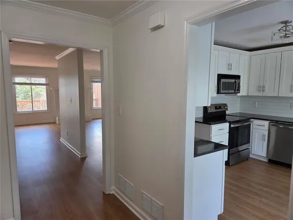 a kitchen with a refrigerator and a stove top oven