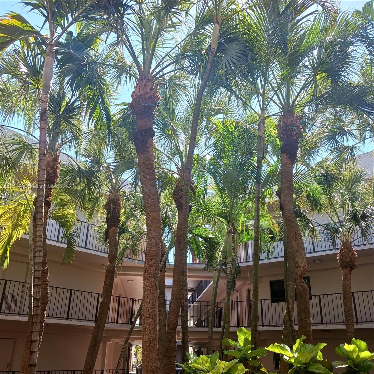 8650 Southwest 133rd Avenue Road, Unit 208 Miami, FL 33183 - Photo 2 of 10 a front view of a house with lots of trees