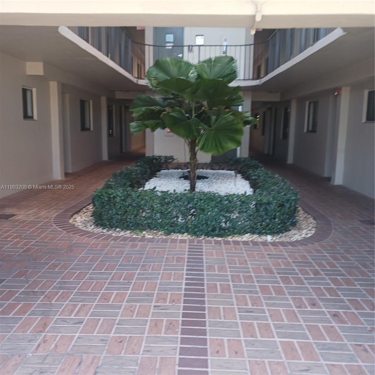 8650 Southwest 133rd Avenue Road, Unit 208 Miami, FL 33183 - Photo 4 of 10 a view of a building with a garden