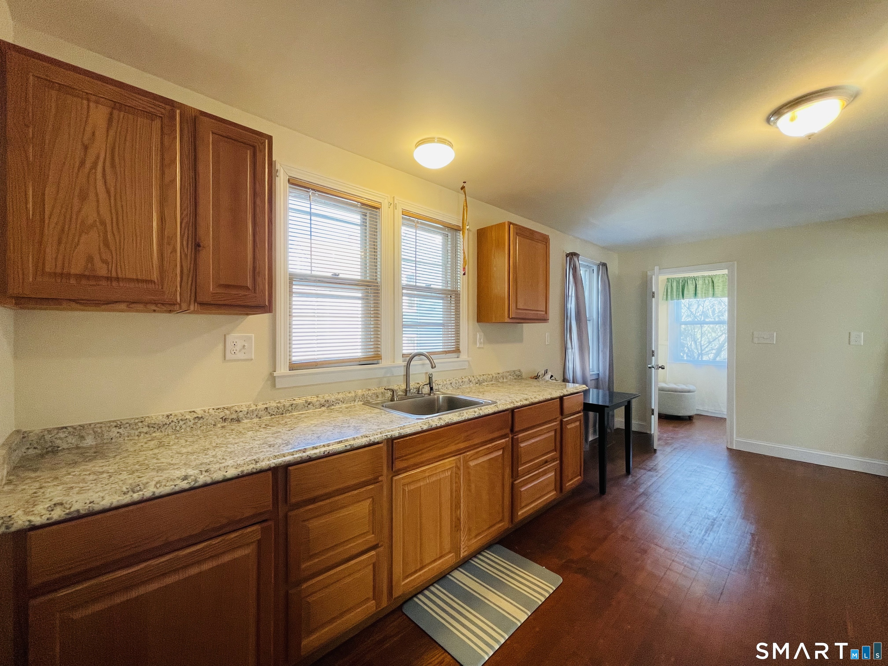 194 Washington Avenue Torrington, CT 06790 - Photo 2 of 7 a kitchen with a sink and wooden cabinets