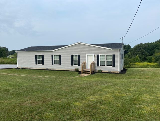 2800 Lock Hollow Road Dickson, TN 37055 - Photo 1 of 26 a front view of a house with a garden