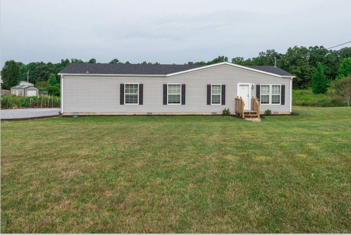 2800 Lock Hollow Road Dickson, TN 37055 - Photo 2 of 26 a view of a yard in front of a house with plants and large trees