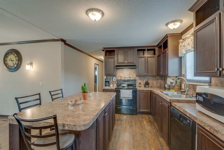 2800 Lock Hollow Road Dickson, TN 37055 - Photo 13 of 26 a kitchen with stainless steel appliances granite countertop a sink a stove a refrigerator cabinets and chairs