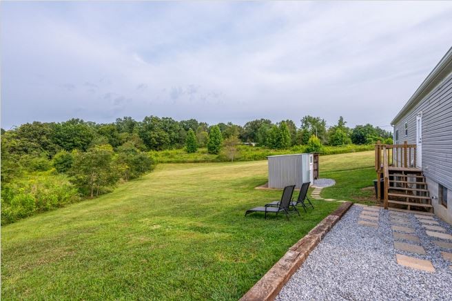 2800 Lock Hollow Road Dickson, TN 37055 - Photo 23 of 26 a view of a garden with a bench in a lake