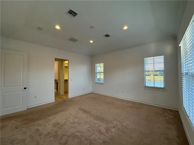 an empty room with windows and closet