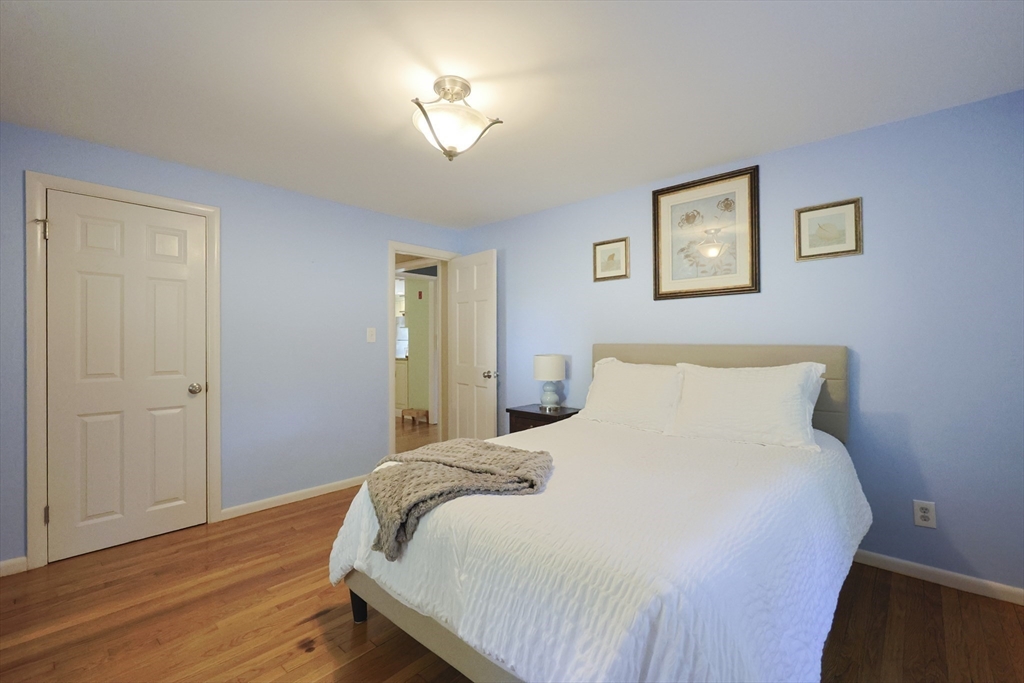 28 Forest Road Millis, MA 02054 - Photo 13 of 23 a bedroom with a bed and a chandelier