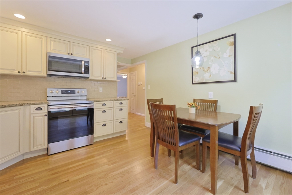 28 Forest Road Millis, MA 02054 - Photo 8 of 23 a view of a dining room with furniture and wooden floor