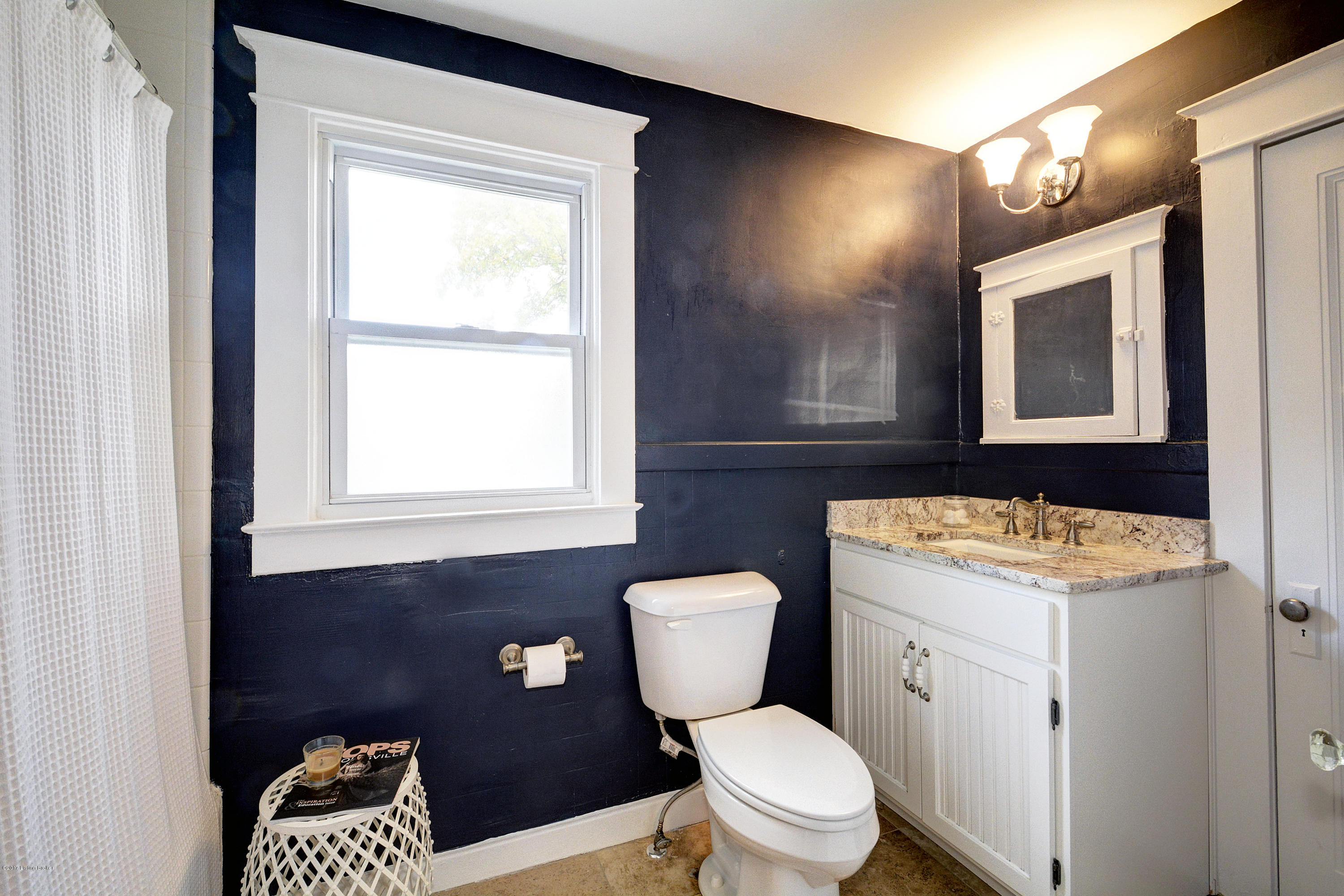 217 Iola Road Louisville, KY 40207 - Photo 27 of 44 The second level bathroom has been renovated to include 12"tile, updated white vanity, and a spacious closet.
