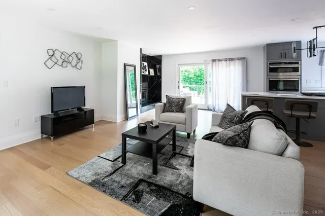 a living room with furniture a fireplace and a table