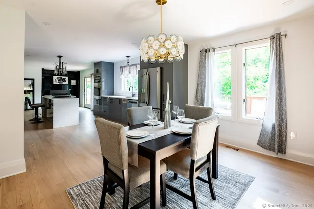 a view of a dining room with furniture wooden floor and chandelier