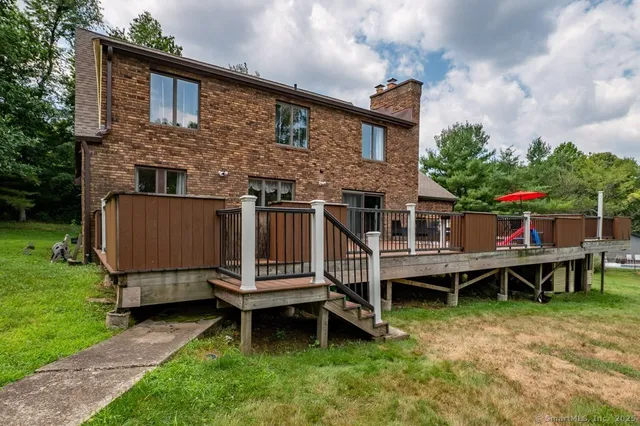 a wooden bench sitting in front of a house