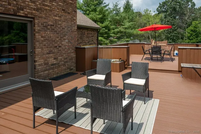 a outdoor living space with furniture and umbrella