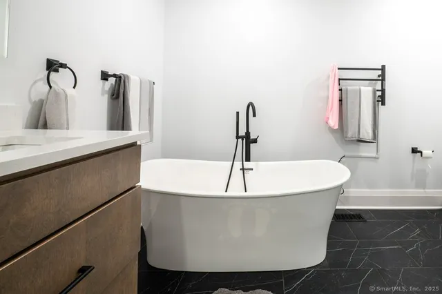 a white bath tub sitting in a bathroom