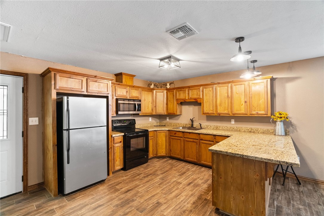 9574 County Road 245 Concepcion, TX 78349 - Photo 6 of 29 a kitchen with a stove a refrigerator and a sink