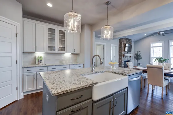 a kitchen with center island table and chairs in it
